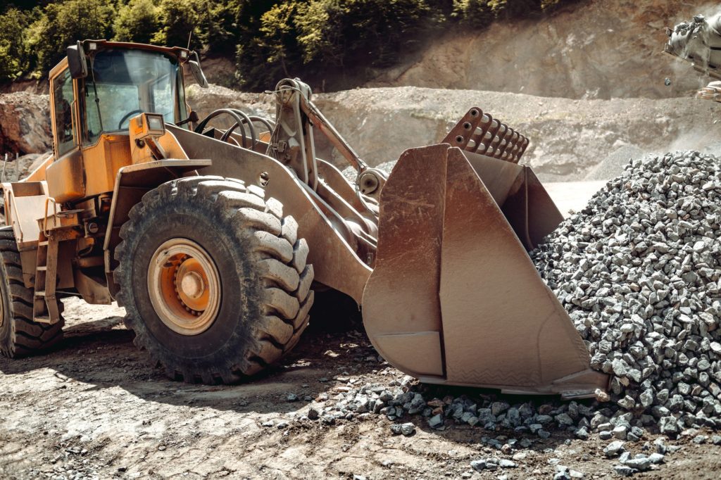 Close up of wheel loader loading gravel and sand materials